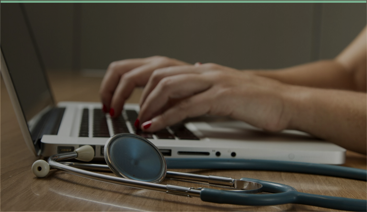Clinical laptop and stethoscope representing healthcare ransomware readiness work